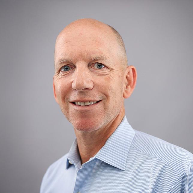 Andy Doolen, professor of English and American Studies at the University of Kentucky College of Arts and Sciences, standing against a plain gray background.